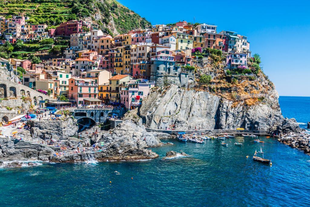 Village of Manarola with ferry, Cinque Terre, Italy