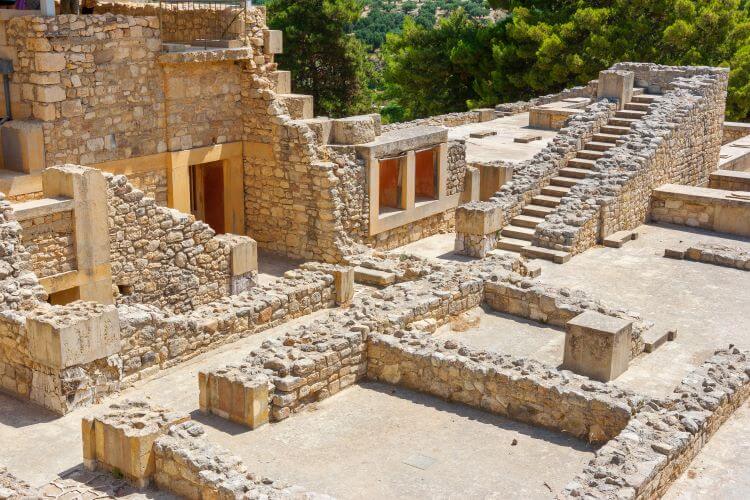 Partial walls, buildings, and reconstructed stairs of the Palace of Knossos, Crete