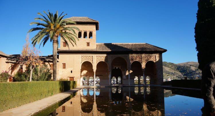 Photo of a view of the buildings of the Alhambra and a reflecting Pool, Granada, Spain
