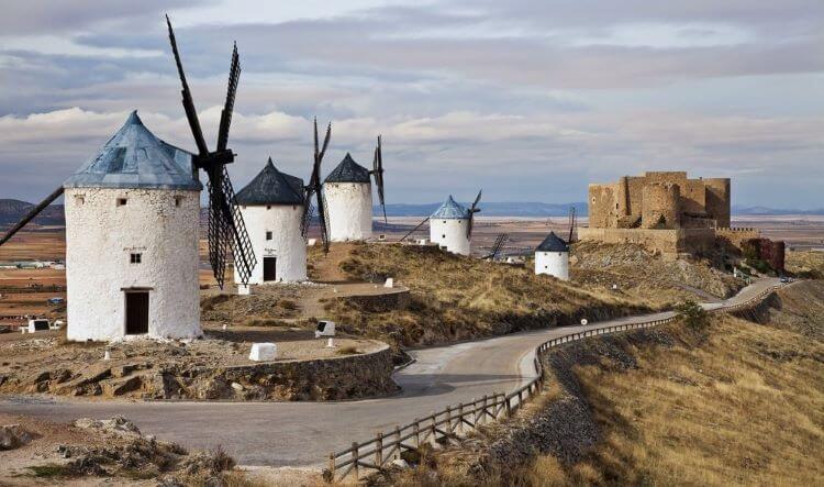 Photo fo the road flanked by the Windmills of Consuegra, Spain
