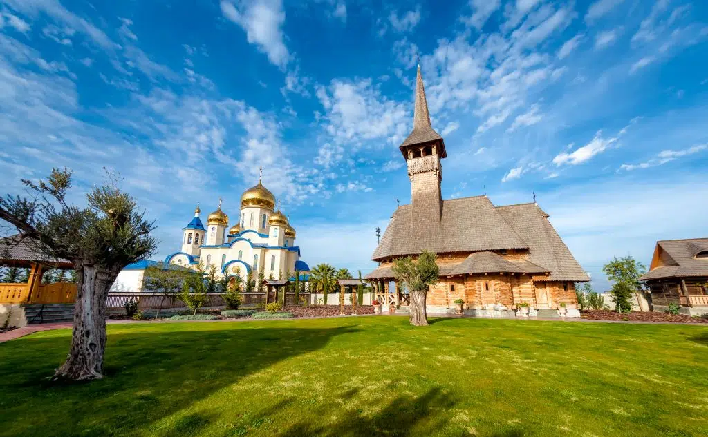 A photo showing the Russian and Romanian Orthodox churches in Episkopeio Village, Cyprus against a bright blue sky