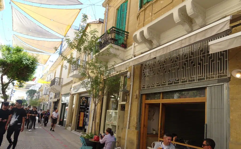 Photo of a Shopping street in the old town, Nicosia, Cyprus, showing the art deco and art nouveau architecture of the two-storey buildings lining the street on both sides
