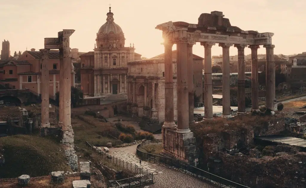 Photo of the Sunrise over the Roman Forum and the ruins of historical buildings in Rome, Italy