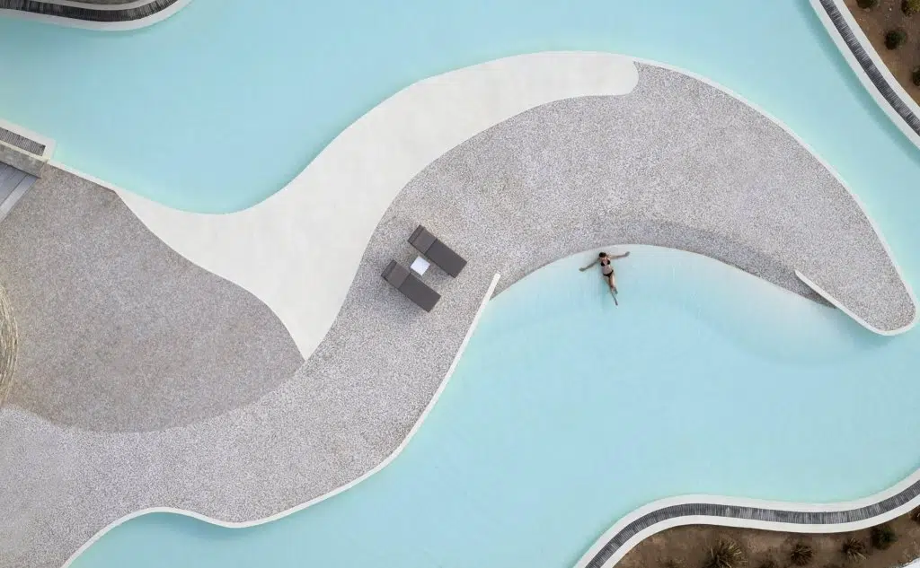 Aerial photo of woman lying in incredible pool at Summer Senses Luxury Hotel, Paros Island, Cyclades, Greece