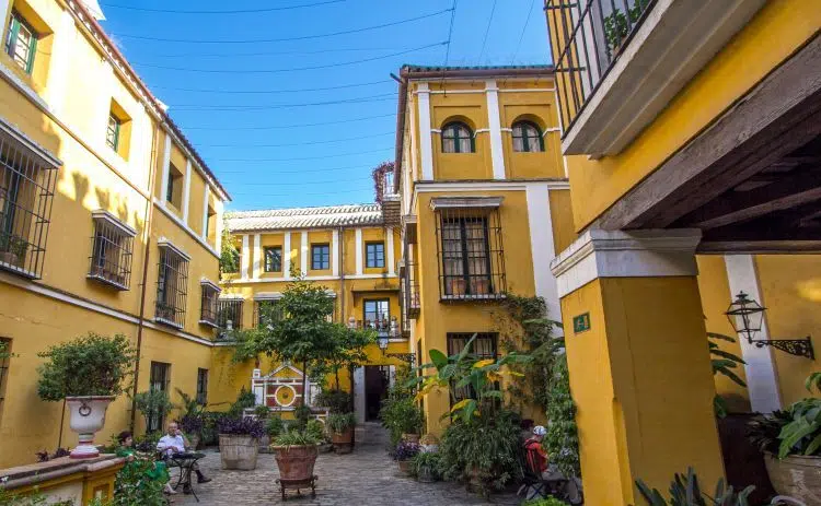 The yellow building of Hotel Las Casas de la Judería