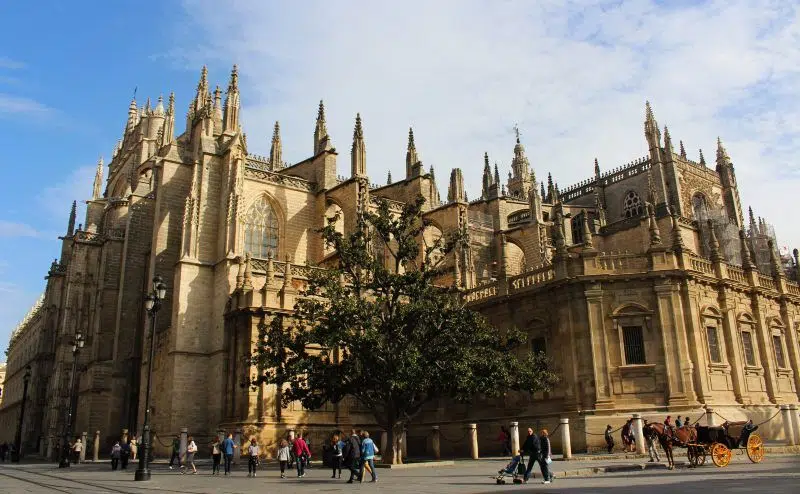 People walking around Seville Cathedral