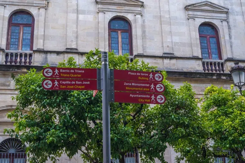 Signs indicating the distance to Seville's most famous attractions for pedestrians