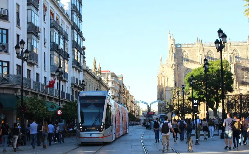 Tram in Seville's lively center with people around